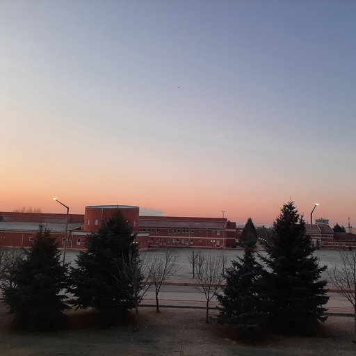 Golden hour sunset over rolling hills with warm orange tones